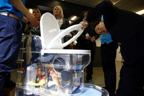 0_A-man-looks-at-a-toilet-design-by-Cranfield-University-at-the-Reinvented-Toilet-Expo-showcasing-sewe.thumb.webp.bd0670d273dd2ada591c1a6619da8b28.webp